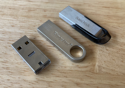 Three different-sized USB keys next to each other