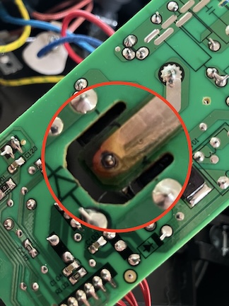 a photo of a circuit board with a discolored solder joint